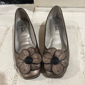 Silver metallic like chunky floral embellished flats with small heel